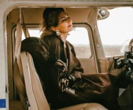 woman pilot smart dress old plane